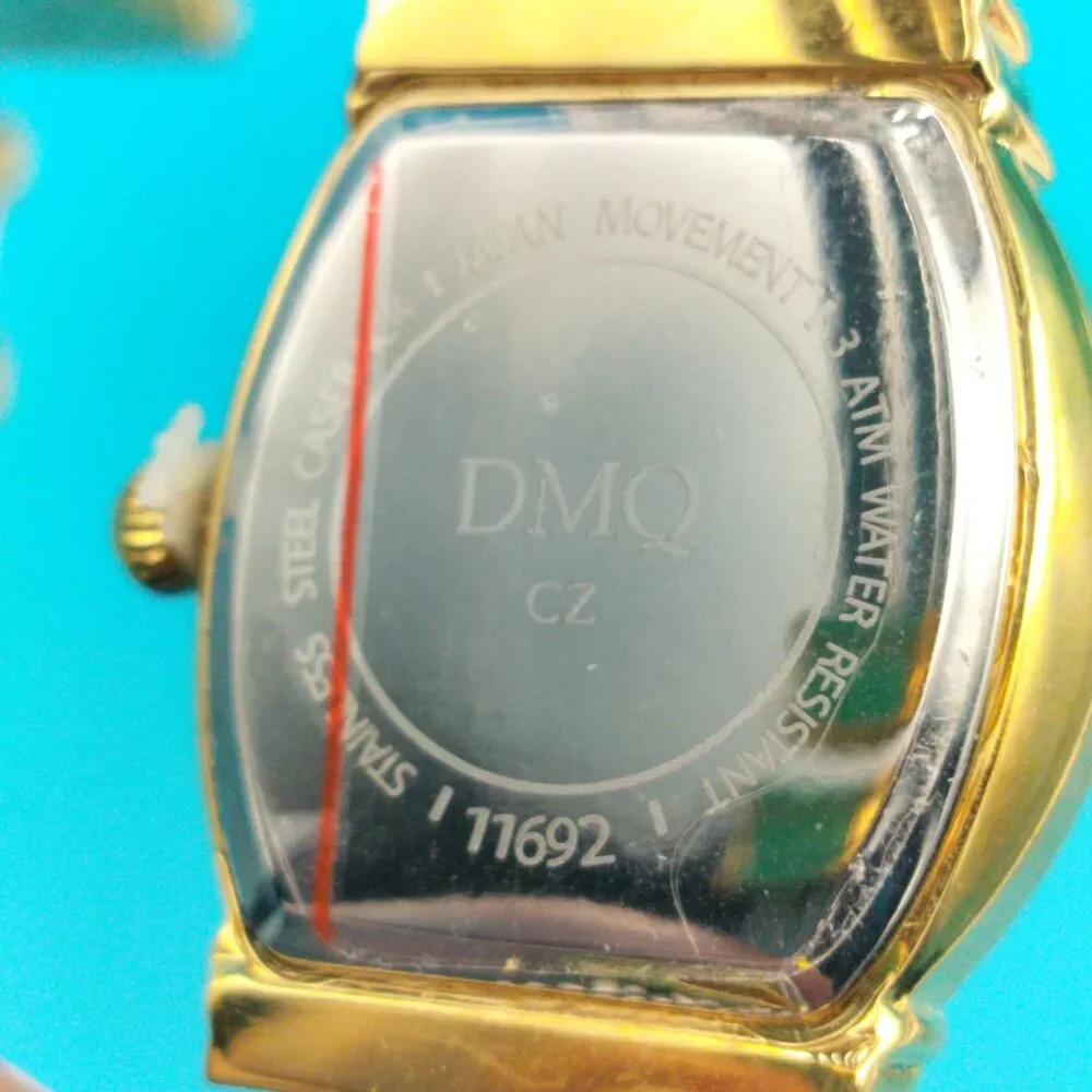 DMQ Women's Gold Tone Cubic Zirconia Mother of Pearl Dial Cable Bangle Watch